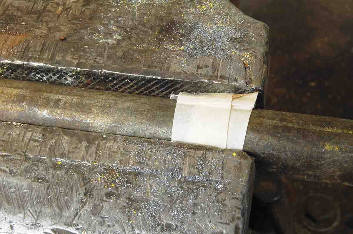 Pipe, inlay and rod are taped together, then squeezed in a vise to bend the inlay.